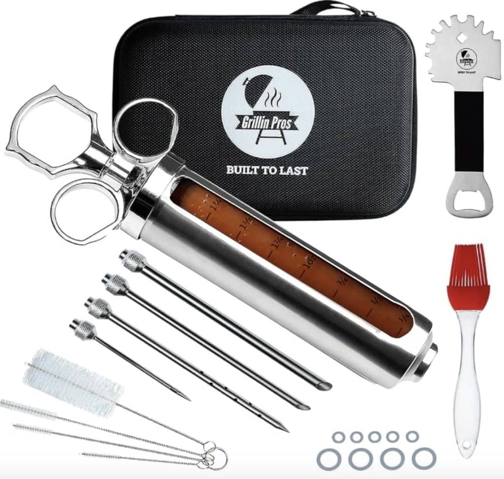 A BBQ injector kit, perfect for learning how to make a tender juicy steak, includes a stainless steel injector syringe, cleaning brush, assorted needles, silicone basting brush, meat claws, bottle opener, and sealing rings. All items are neatly packed in a black carrying case labeled "Grillin Pro.